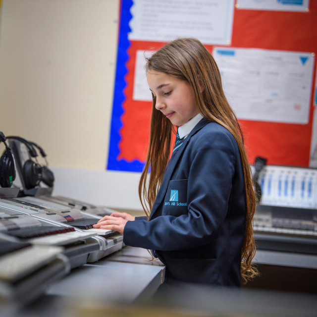 School child playing a keyboard